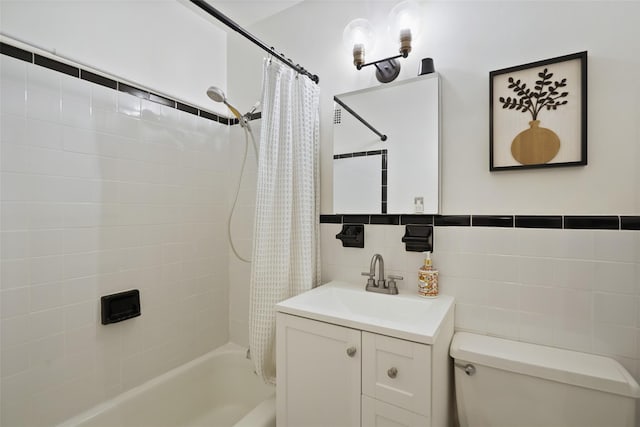 bathroom with vanity, tile walls, toilet, and shower / tub combo with curtain