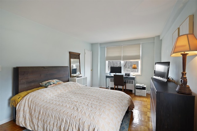 bedroom featuring radiator and baseboards