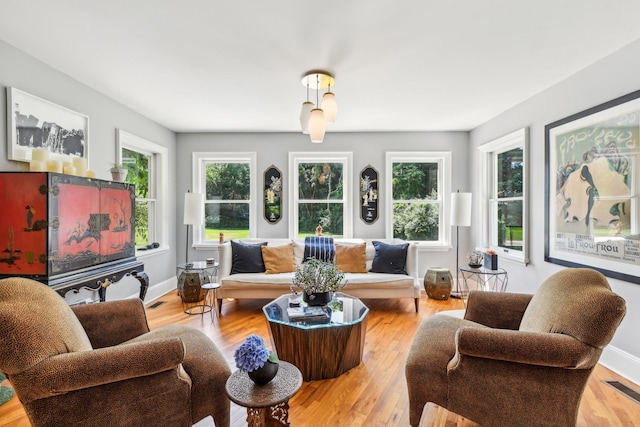 interior space with light wood finished floors, baseboards, and visible vents