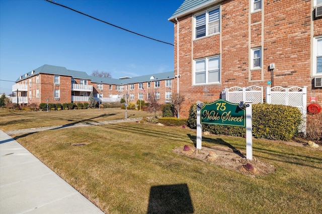 view of property's community with a lawn