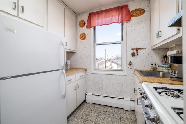 kitchen featuring white cabinets, white appliances, light countertops, and wallpapered walls