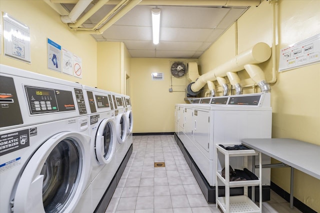 shared laundry area with light tile patterned floors, baseboards, and washer and dryer