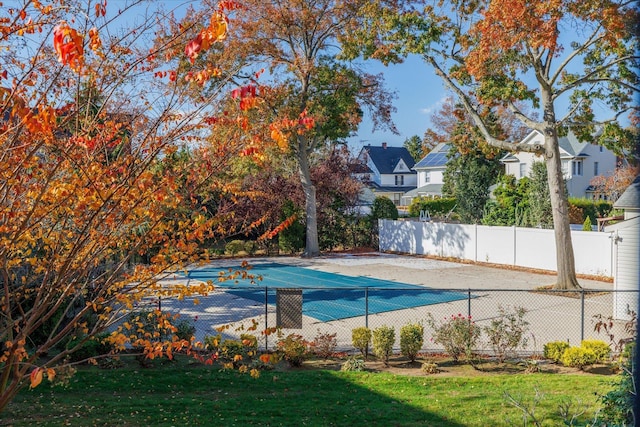 view of pool with a residential view, fence, a fenced in pool, and a yard