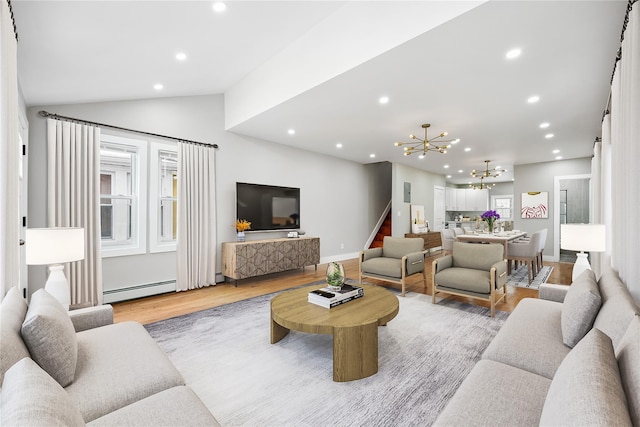 living room featuring lofted ceiling, an inviting chandelier, light hardwood / wood-style floors, and baseboard heating