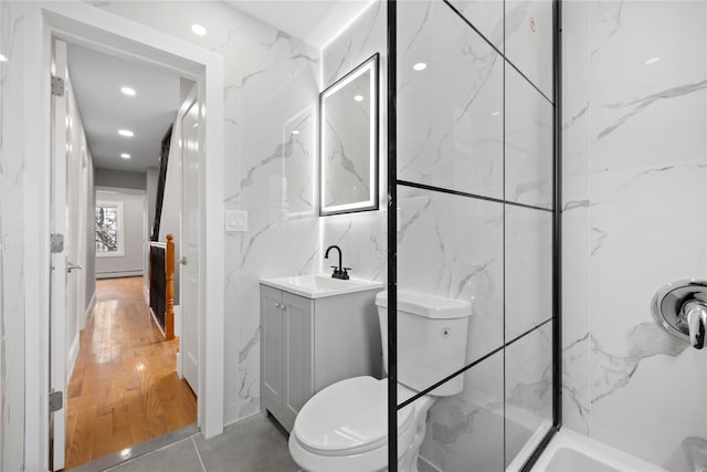 bathroom with tile walls, toilet, vanity, and wood-type flooring