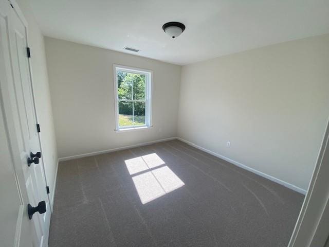 unfurnished bedroom featuring dark carpet