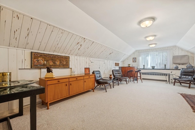 interior space with radiator, lofted ceiling, and wooden walls