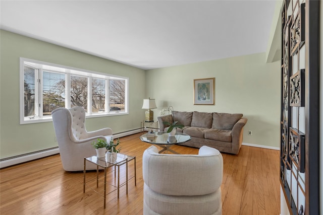 living room with wood finished floors, baseboards, and baseboard heating