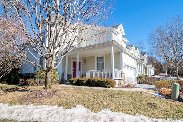 view of front facade with a garage, a porch, and a front yard