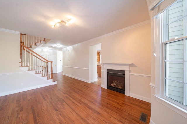 unfurnished living room with hardwood / wood-style flooring and ornamental molding