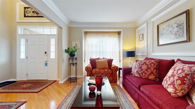 entryway with baseboards, hardwood / wood-style flooring, and crown molding