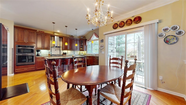 dining space with light wood-type flooring, baseboards, visible vents, and a chandelier