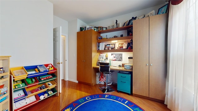 interior space featuring built in study area and light wood-style flooring