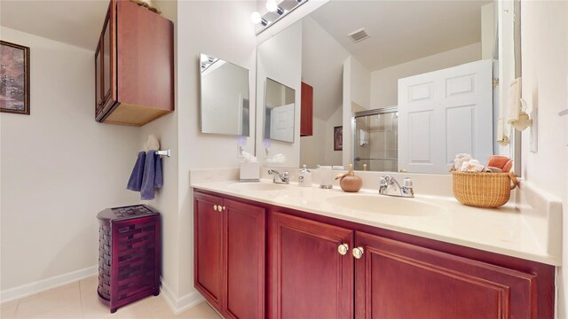 full bathroom with a stall shower, tile patterned flooring, a sink, and double vanity