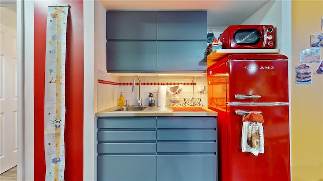 interior space with backsplash and a sink