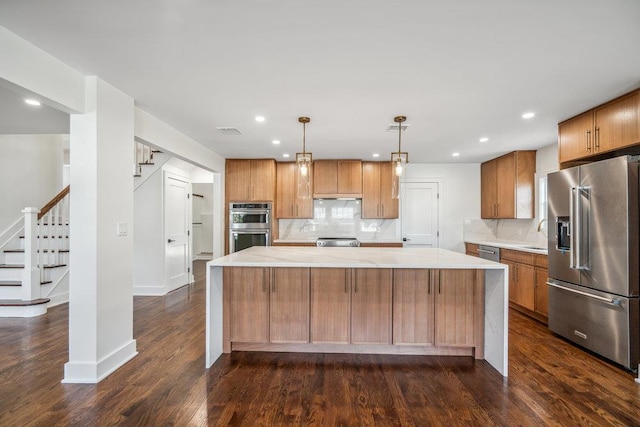 kitchen with stainless steel appliances, light countertops, visible vents, and decorative backsplash