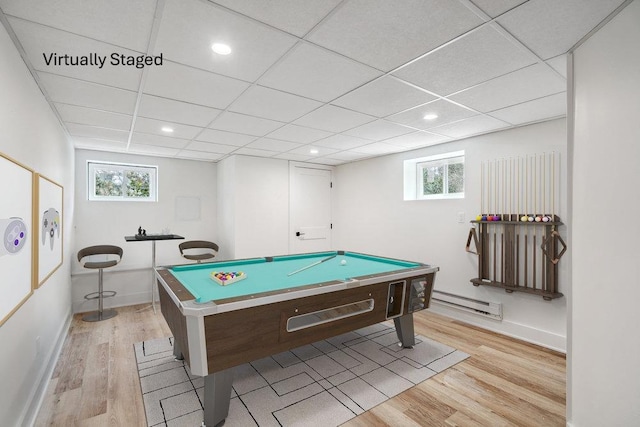 game room featuring light wood-style floors, baseboard heating, a drop ceiling, and pool table