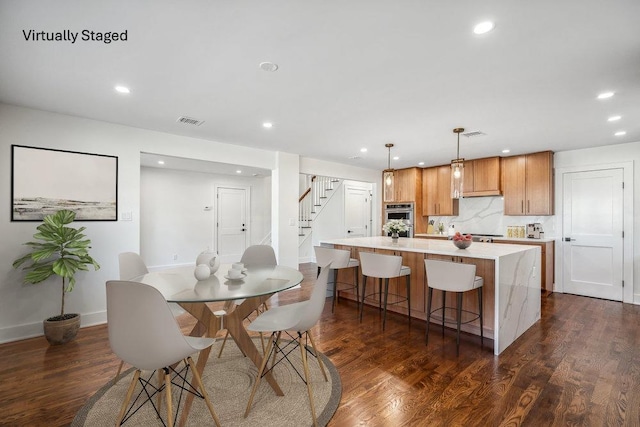 dining space with recessed lighting, visible vents, dark wood finished floors, and stairs