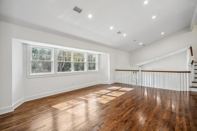 unfurnished room with visible vents, recessed lighting, hardwood / wood-style flooring, and baseboards