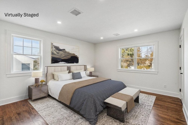 bedroom with recessed lighting, visible vents, baseboards, and wood finished floors