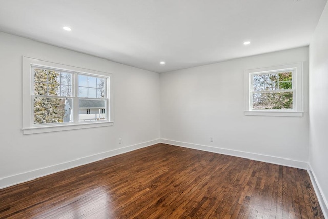 spare room with dark wood-style floors, baseboards, and recessed lighting