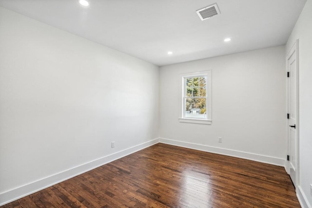 unfurnished room with dark wood-style floors, recessed lighting, visible vents, and baseboards