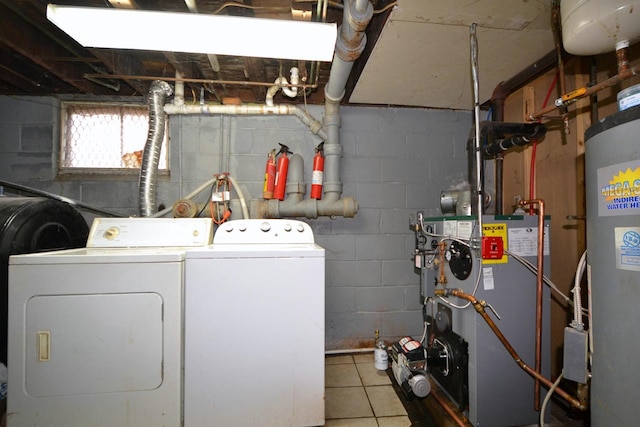 clothes washing area featuring gas water heater, laundry area, a heating unit, and washing machine and dryer