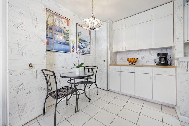 dining space with light tile patterned floors and a chandelier