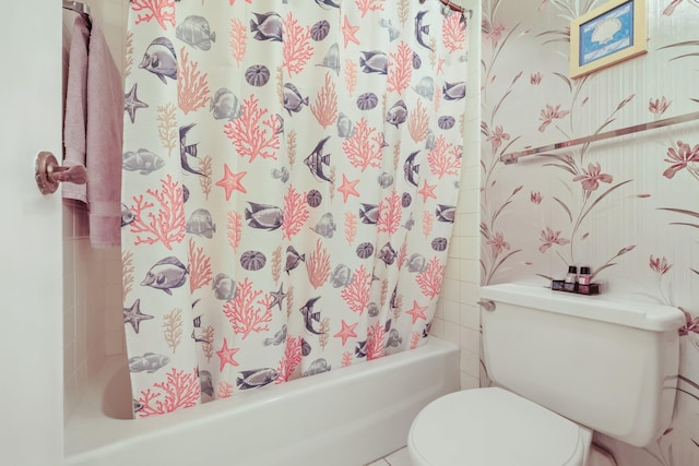 full bathroom featuring shower / bath combo with shower curtain and toilet