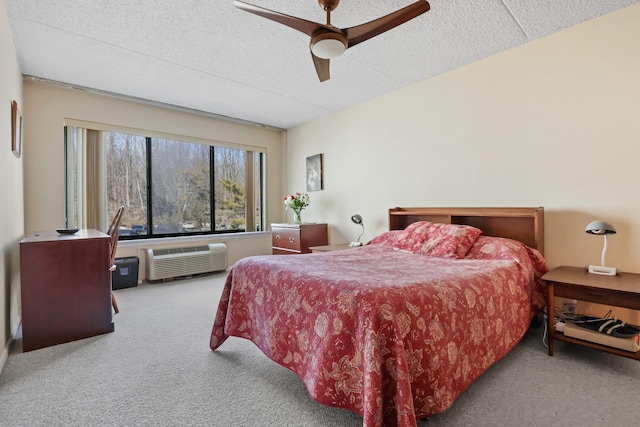 bedroom featuring a textured ceiling, an AC wall unit, carpet, and a ceiling fan