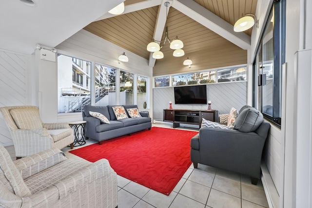 living area featuring lofted ceiling, light tile patterned flooring, wood ceiling, and wooden walls