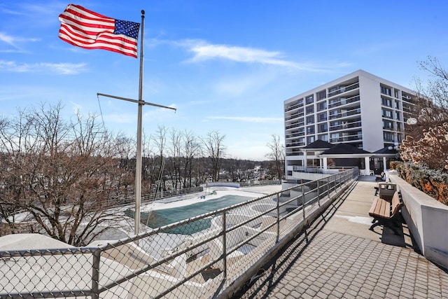 exterior space with fence and a community pool