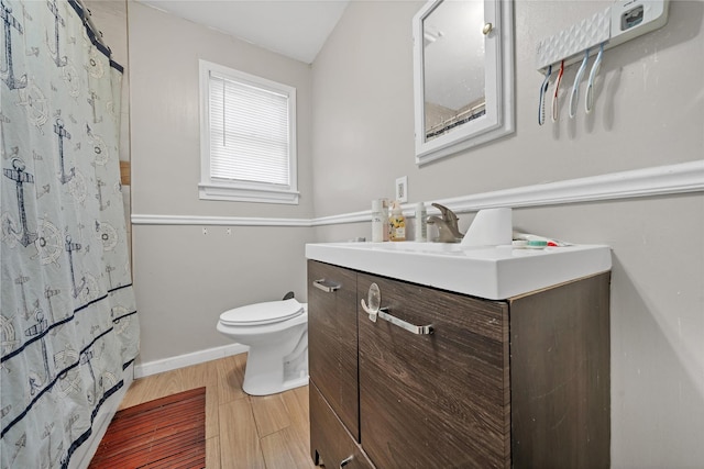 bathroom featuring hardwood / wood-style floors, toilet, a shower with curtain, and vanity