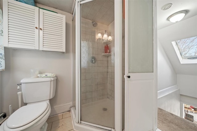 bathroom with toilet, a skylight, and a shower with shower door