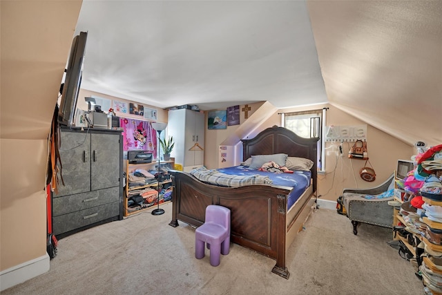 bedroom with light carpet and vaulted ceiling