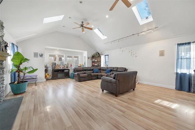 living room featuring ceiling fan, high vaulted ceiling, light wood-type flooring, and rail lighting