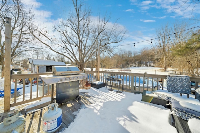 snow covered deck featuring grilling area