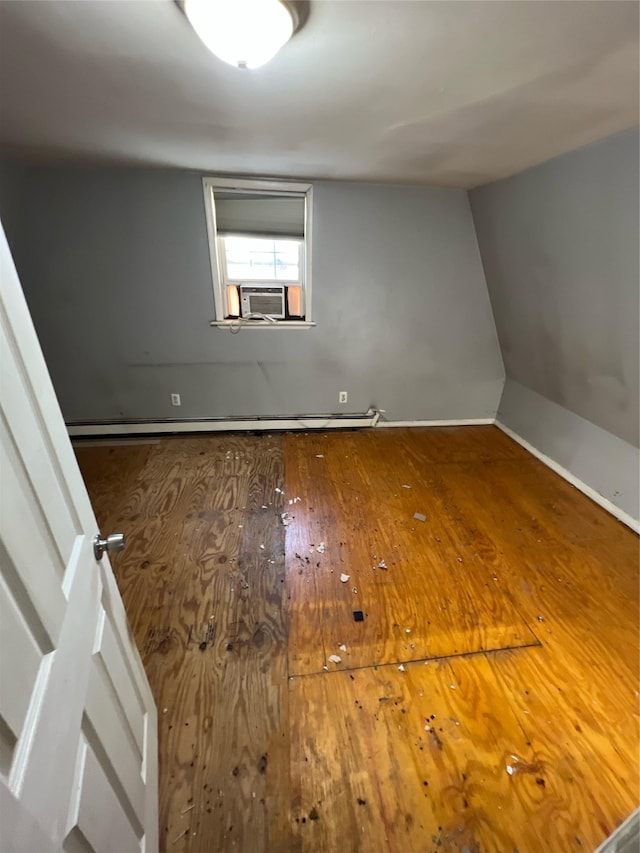 unfurnished room with cooling unit and wood-type flooring