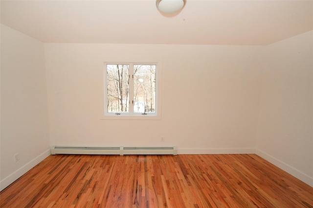 empty room featuring light hardwood / wood-style flooring and a baseboard radiator