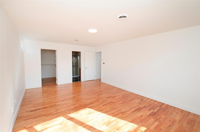 spare room with light wood-type flooring