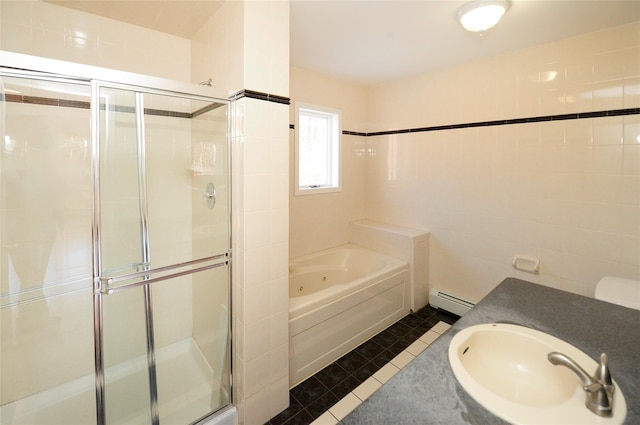 bathroom with tile walls, a baseboard radiator, vanity, independent shower and bath, and tile patterned flooring