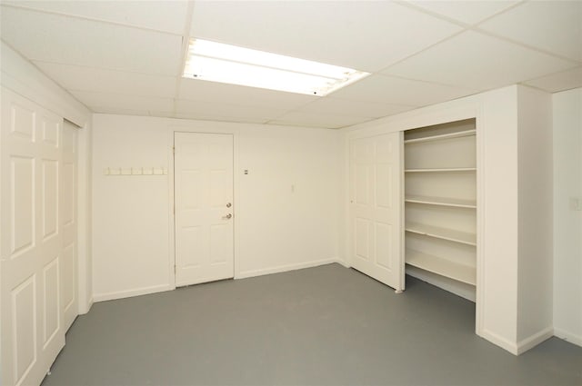 basement with a paneled ceiling