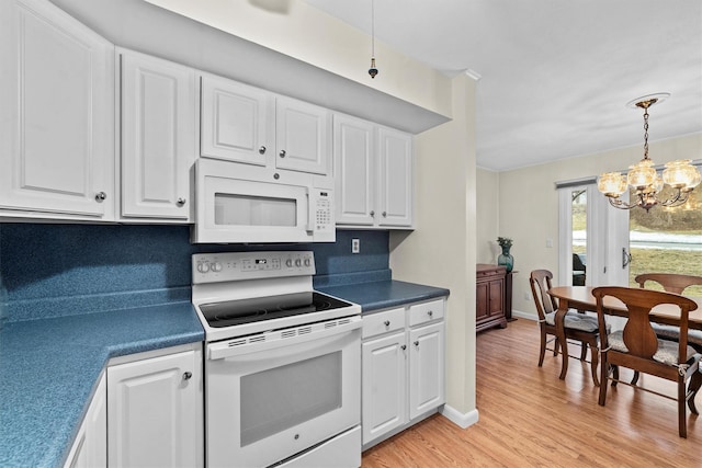 kitchen featuring white appliances, white cabinetry, a notable chandelier, and light wood finished floors