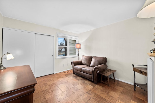 living area with visible vents and baseboards