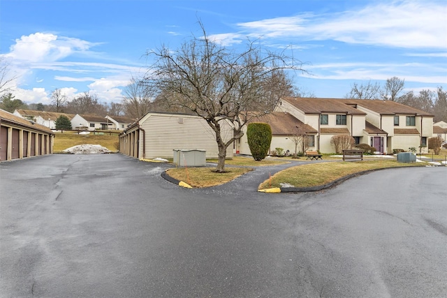 view of road with a residential view and community garages