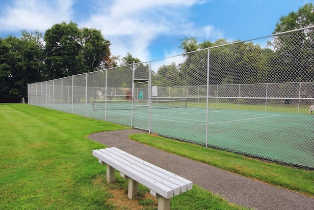 view of sport court featuring a lawn and fence