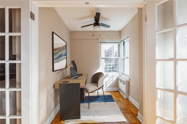 home office with radiator, light parquet floors, and ceiling fan