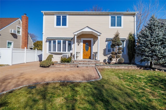 view of front of house with fence and a front yard