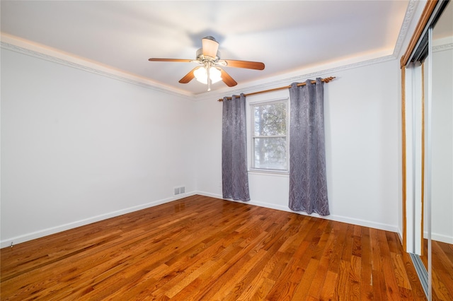 unfurnished room featuring baseboards, ornamental molding, and wood finished floors