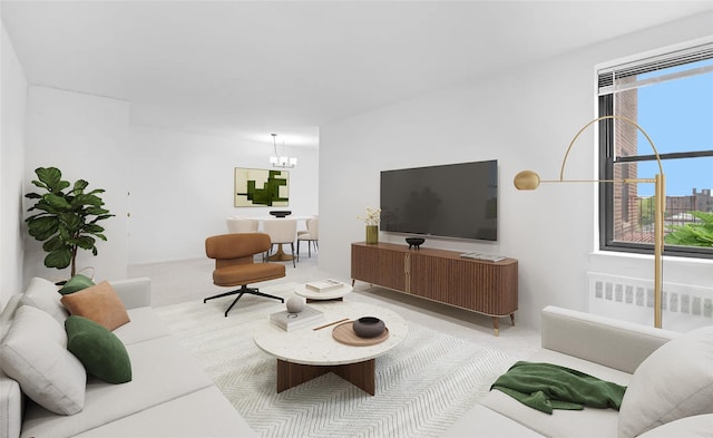 carpeted living room featuring radiator and an inviting chandelier